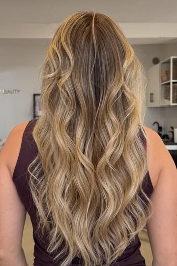 Long balayage hair in soft waves, styled at FLOR